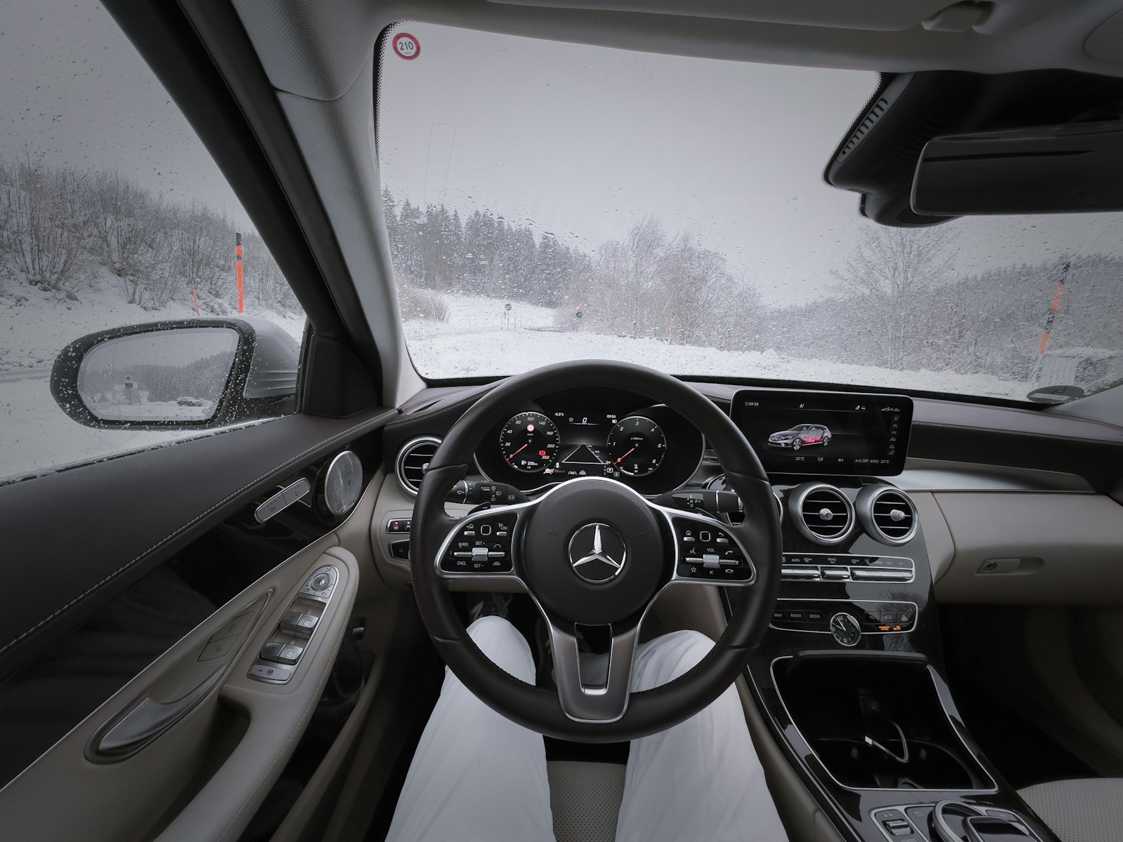 a car driving down a snow covered road, winter driving